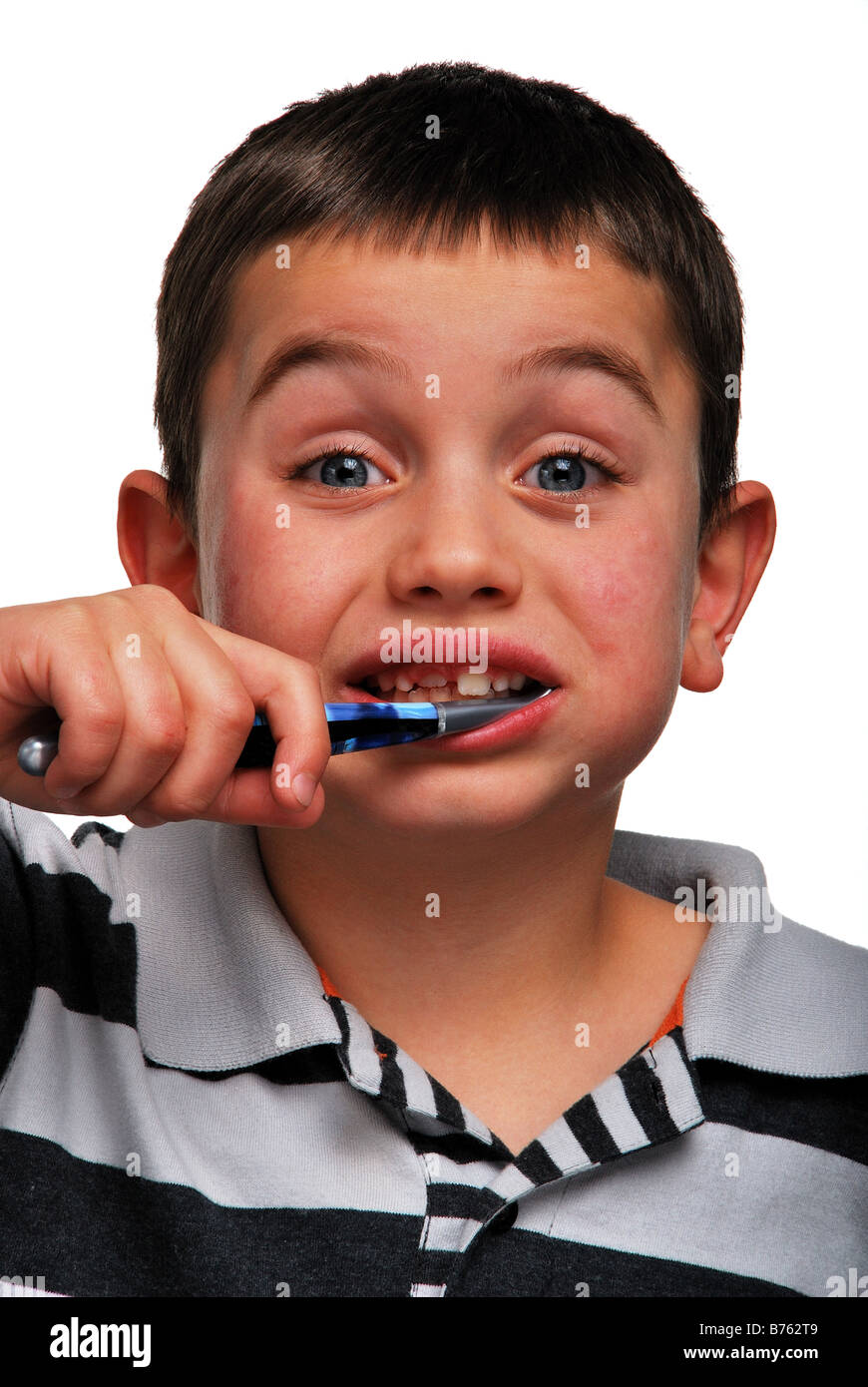 a young boy brushing his teeth Stock Photo