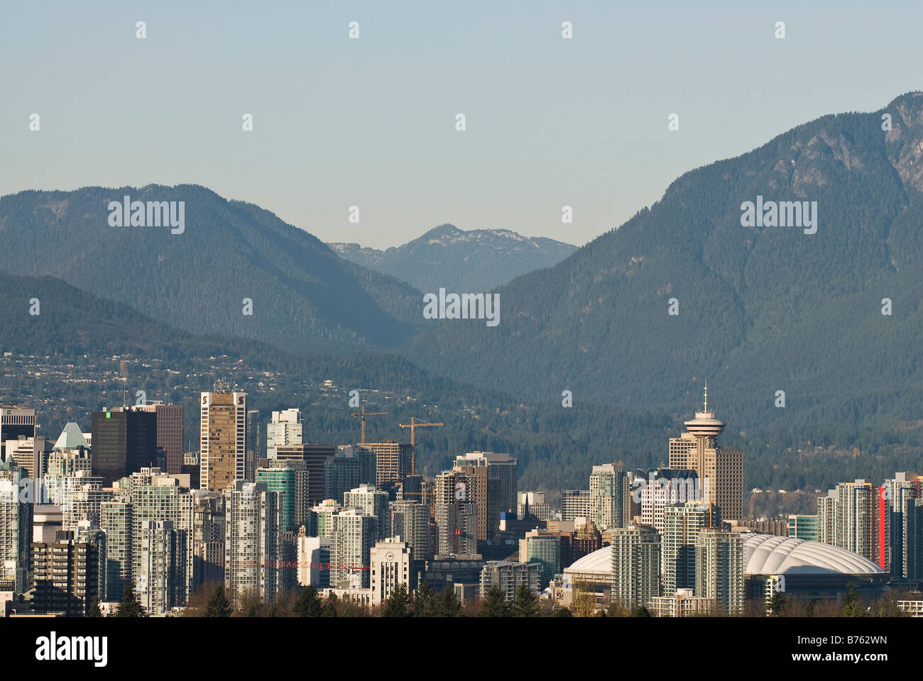 A view of the ever changing skyline of the downtown area of Vancouver set against the mountains on the north shore. Stock Photo
