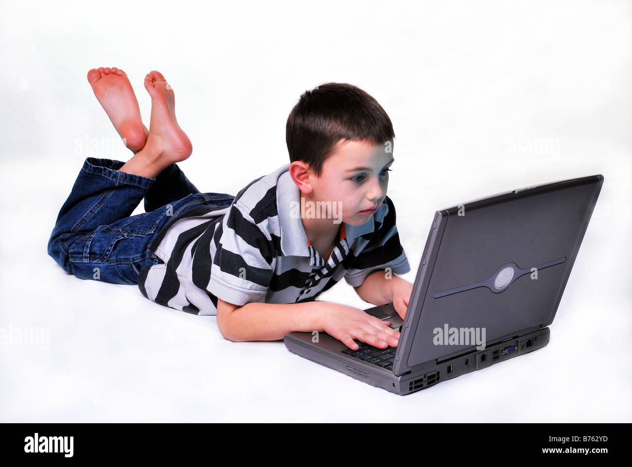 A young boy searching the internet on a laptop computer Stock Photo - Alamy