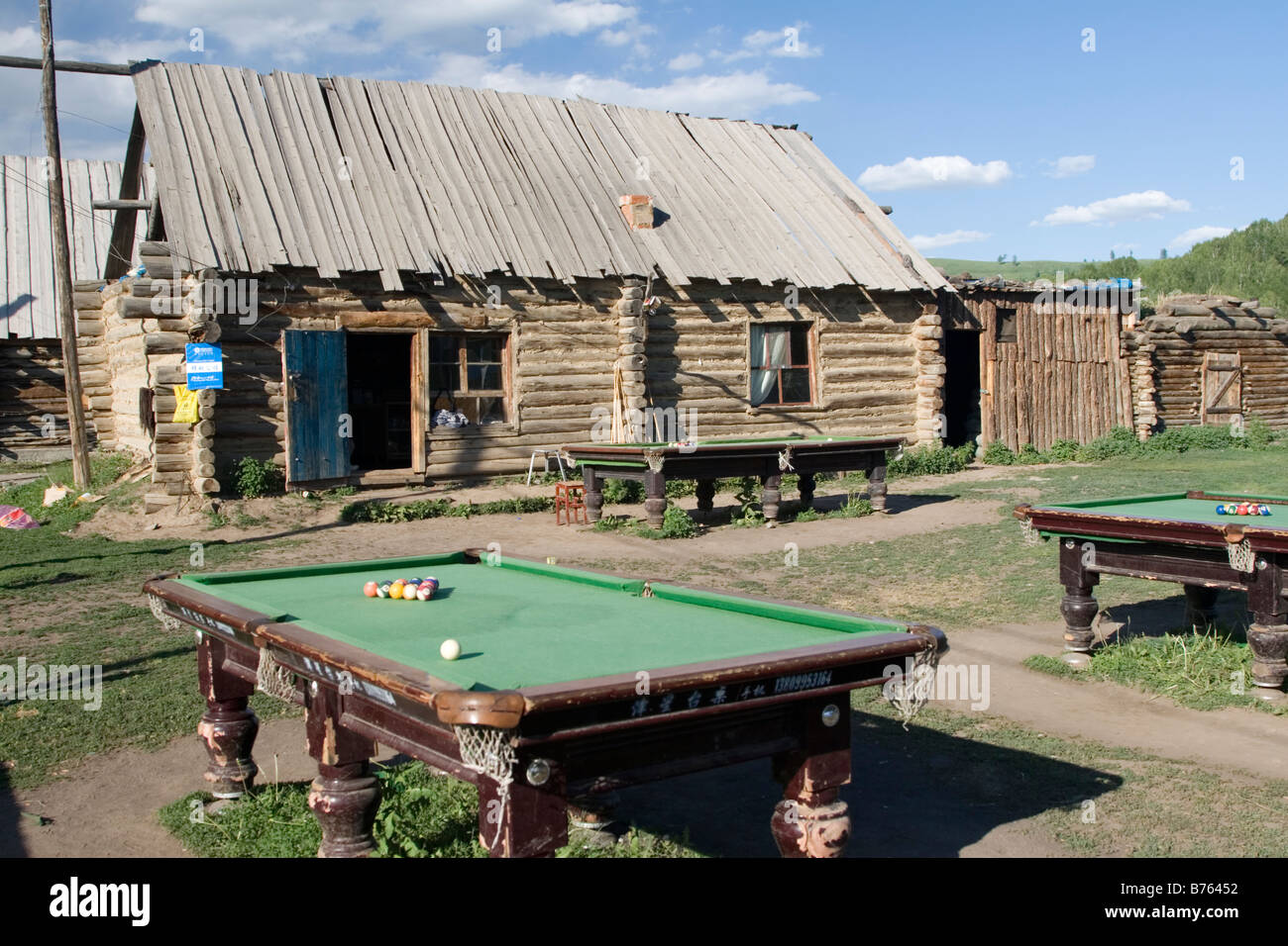 Billiard tables outside a rustic bar in Hemu in Kanas in Xinjiang in China. Stock Photo