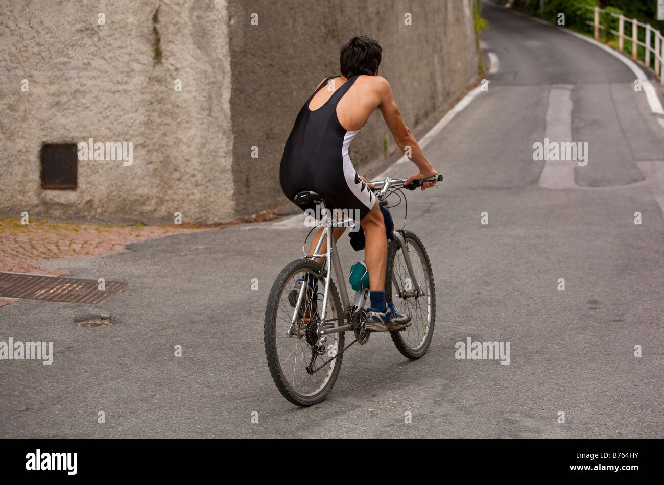 An Italian man in biking clothing rides in the town of Brunate ...