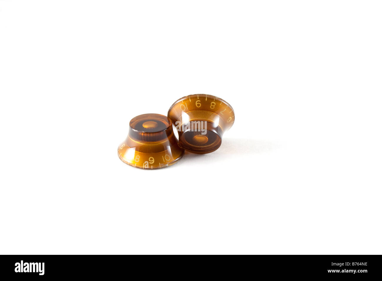 Old amber colored guitar knobs Stock Photo