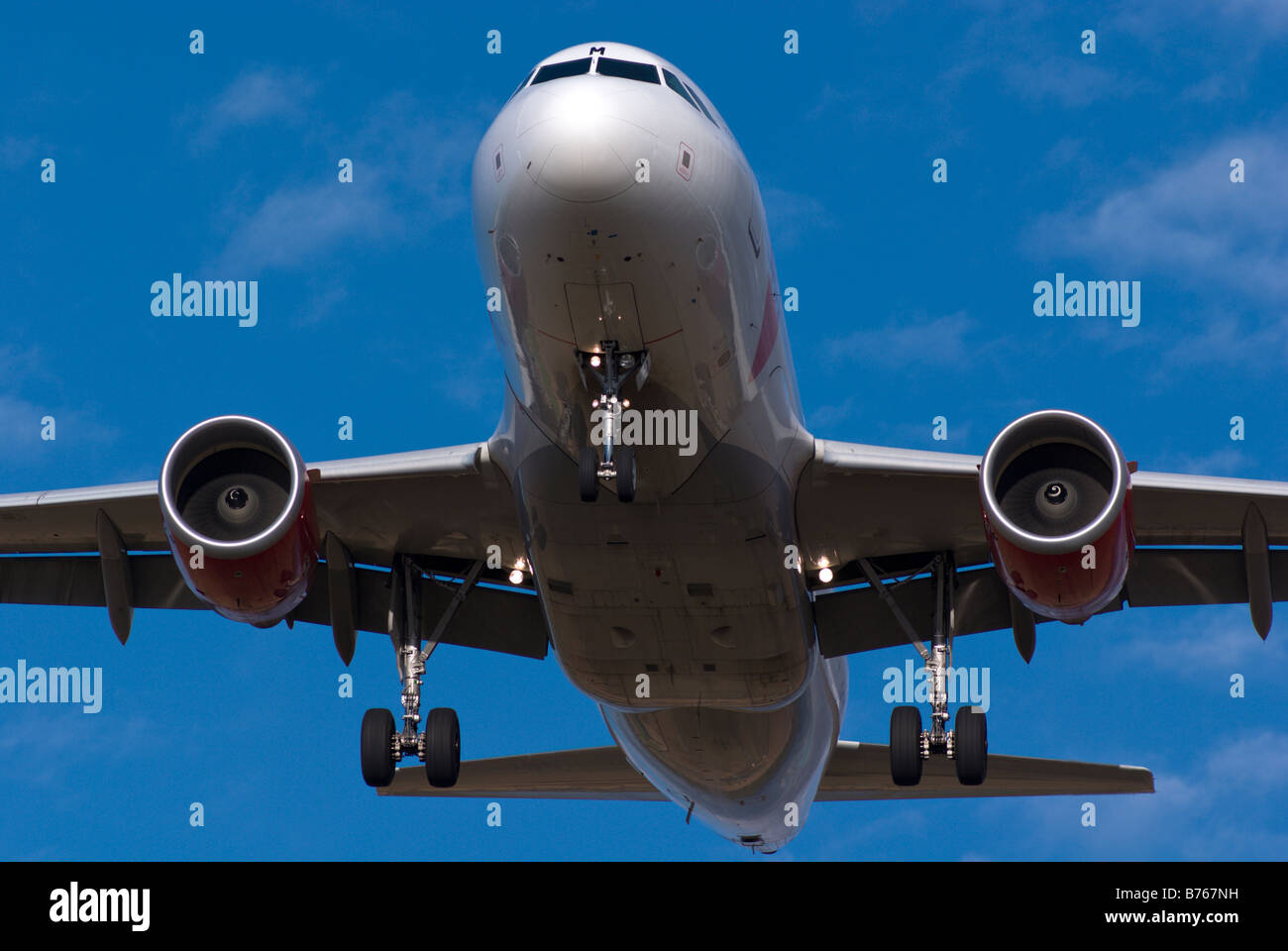 CSA Czech Airlines Airbus A319 jet airliner final approach, with clearly visible landing gear detail,flaps down,under blue sky. Stock Photo