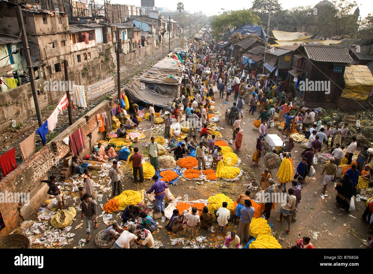 People buy and sell flowers at the colourful Mullick Ghat ...