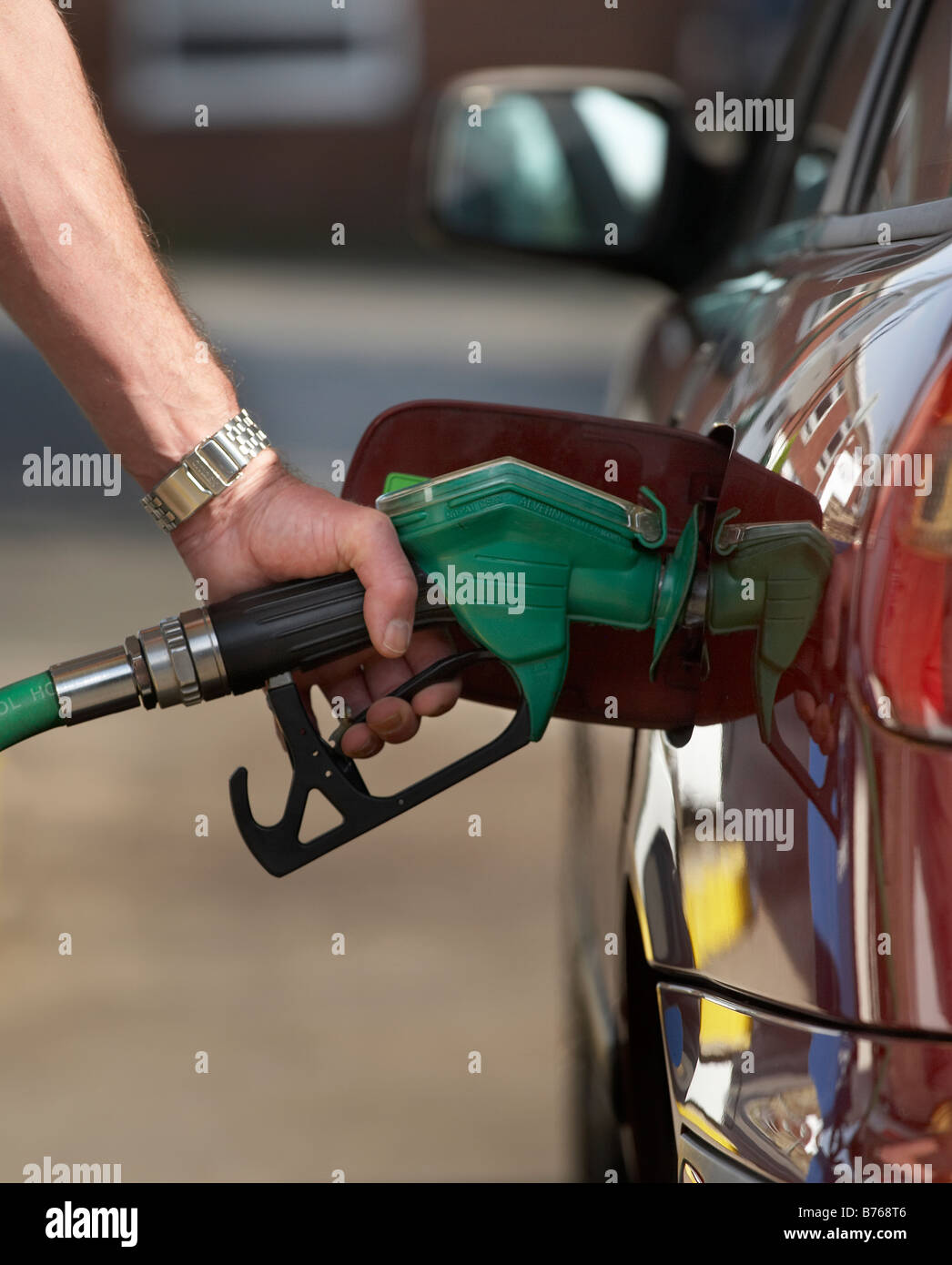 MAN FILLING CAR AUTOMOBILE GAS GASOLINE FUEL PETROL DIESEL TANK Stock