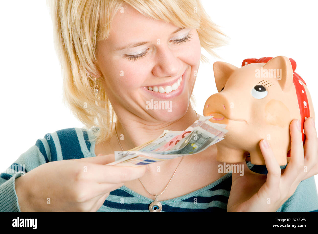 young blond girl with piggybank Stock Photo