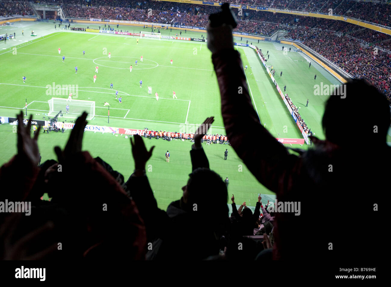 fans at football game cheering a goal being scored, Nissan Stadium , Shin-Yokohama, Japan Stock Photo