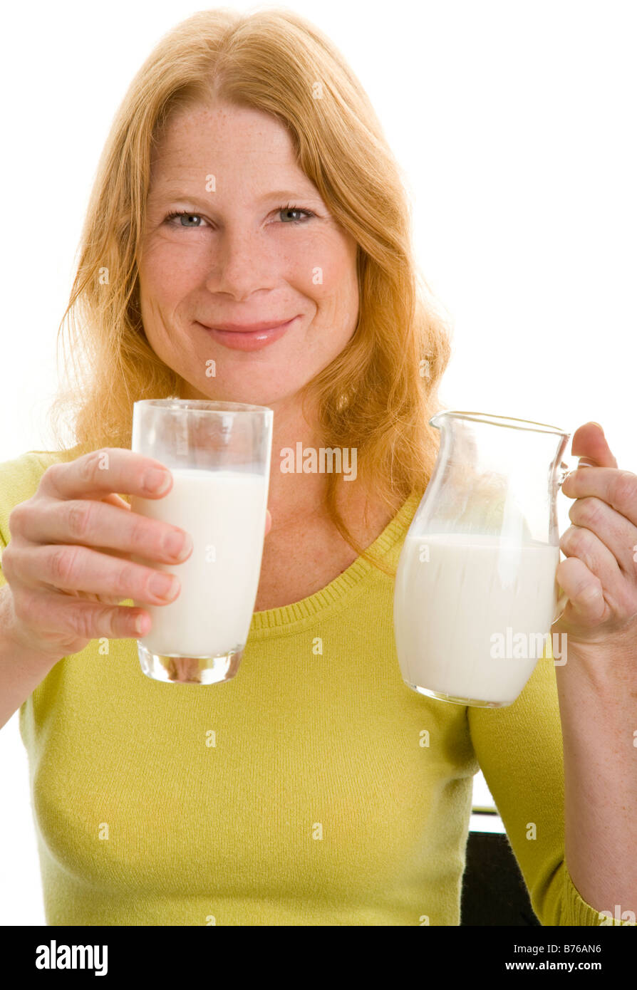 redhead woman drinking a glass of milk Stock Photo