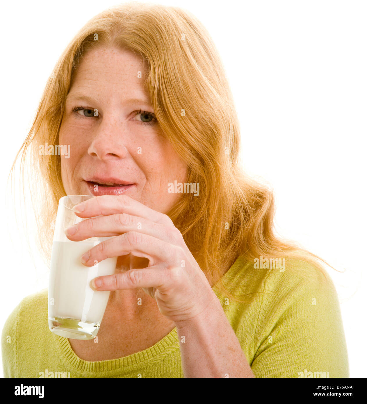 redhead woman drinking a glass of milk Stock Photo