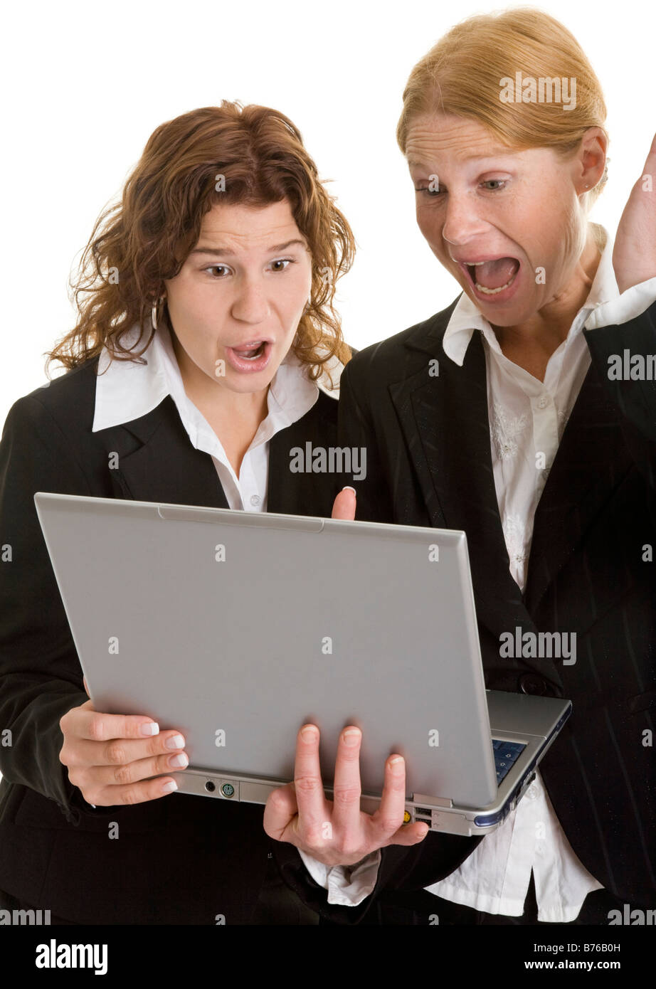 two angry businesswoman women with laptop Stock Photo