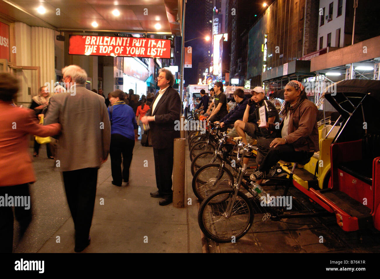Pedicabs line up outside a Broadway theatre as the audience leaves after a performance in New York City theatre district Stock Photo