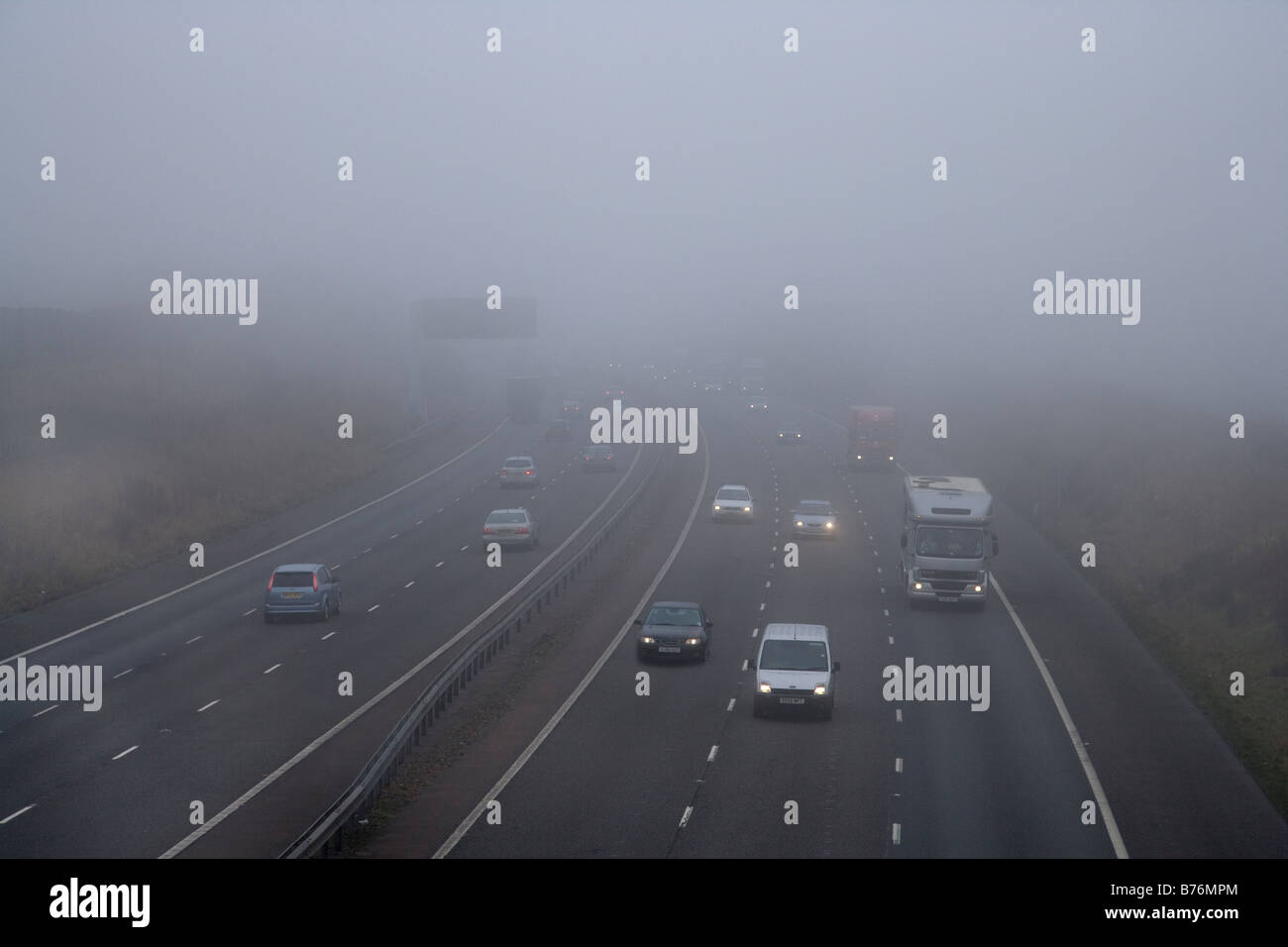 Cars and lorries on motorway in fog , uk Stock Photo