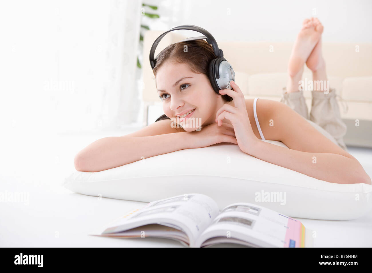 Teenage girl lying on floor wearing headphone smiling portrait Stock ...