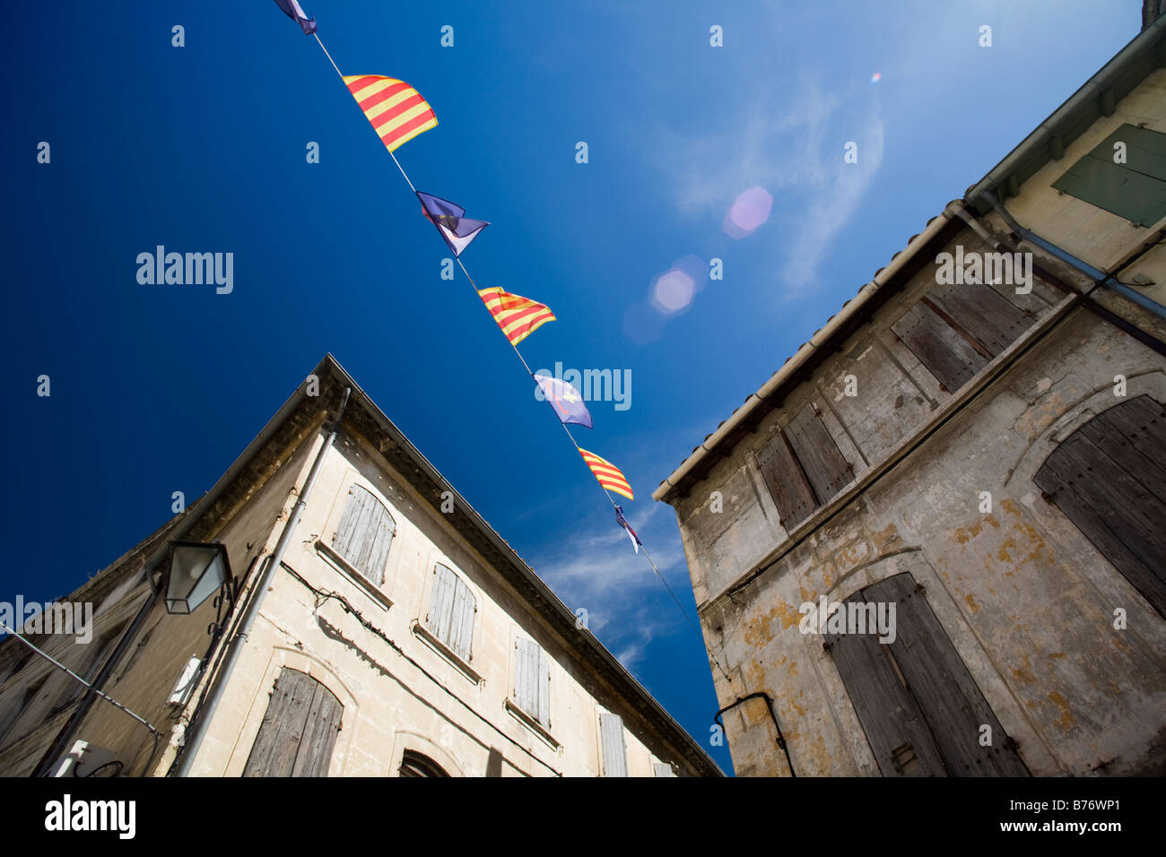 Tarascon main street houses facade and flags, Bouche du Rhone, France