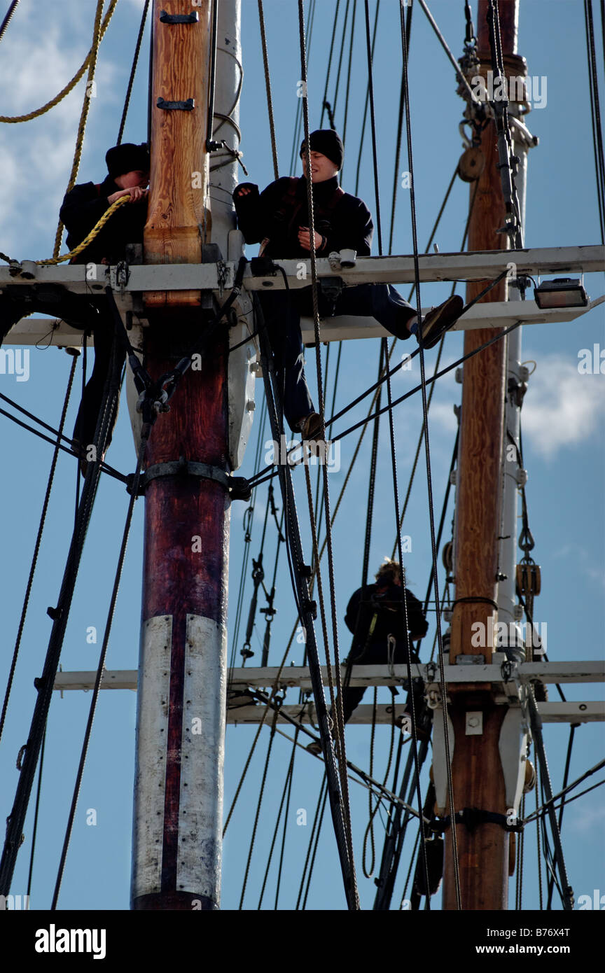 Two women working high in the rigging of a tall ship Stock Photo - Alamy
