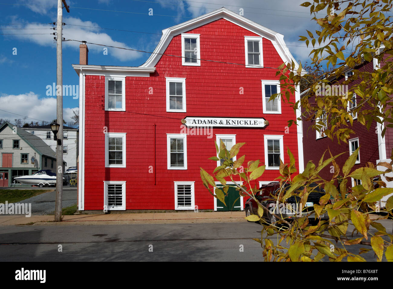 The bright red Adams and Knickle building in Lunenburg Nova Scotia Stock Photo