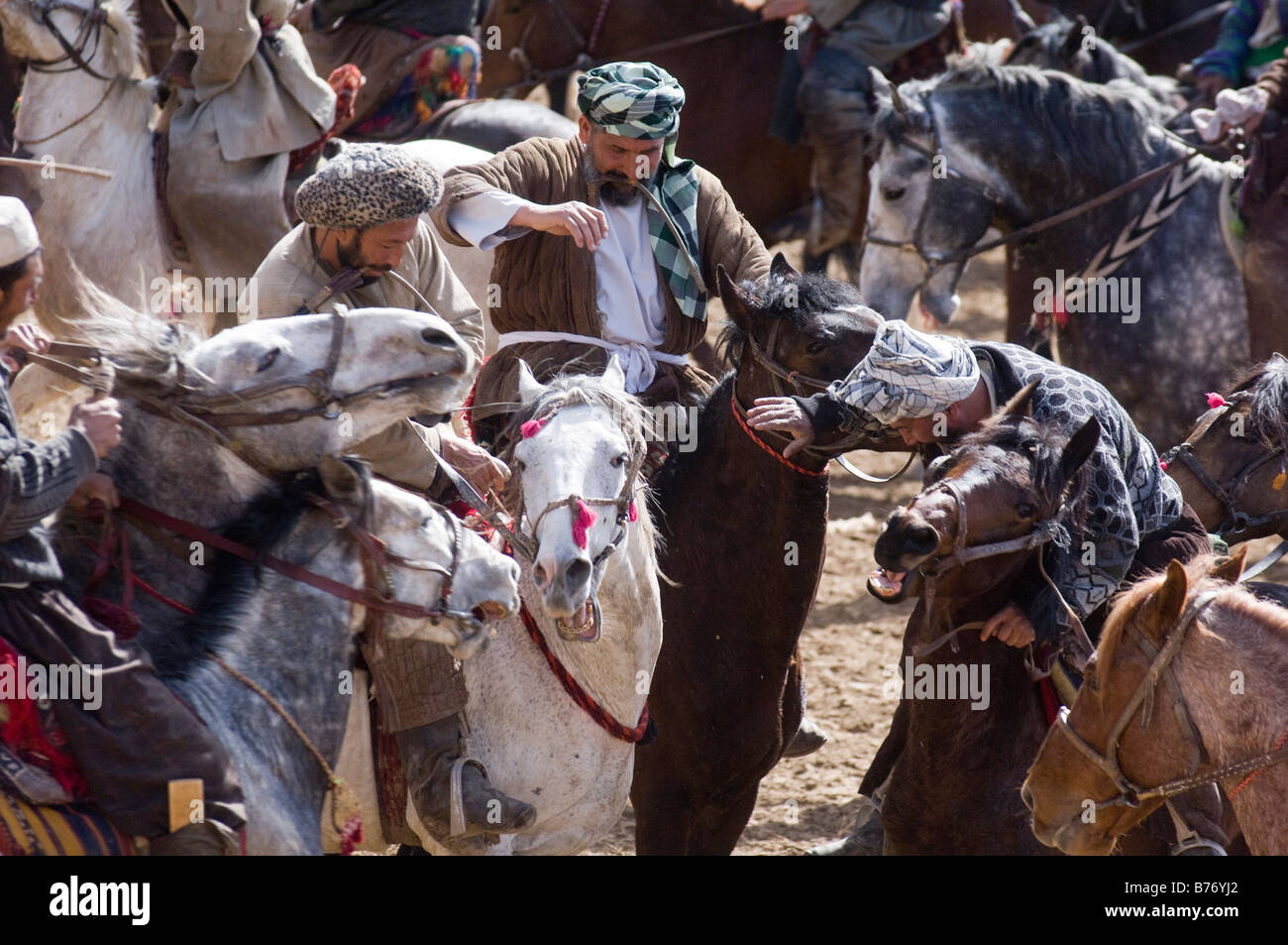 Afghan horsemen take part in the traditional Buzkashi game in Maimana Afghanistan on Tuesday 19th February 2008. Stock Photo