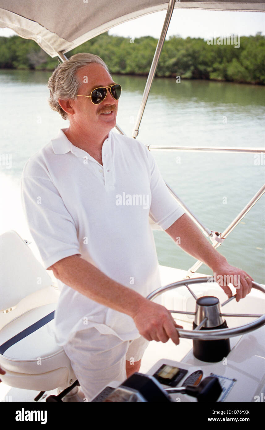 Man Steering Motorboat Stock Photo - Alamy