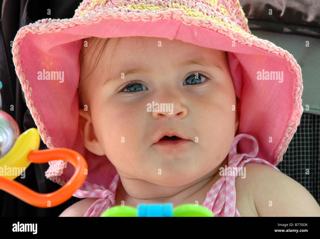 baby girl child happy hat joyful smile look Stock Photo