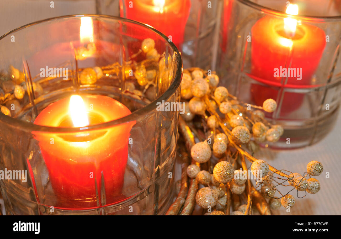 Lighted red candles in glass containers Stock Photo Alamy