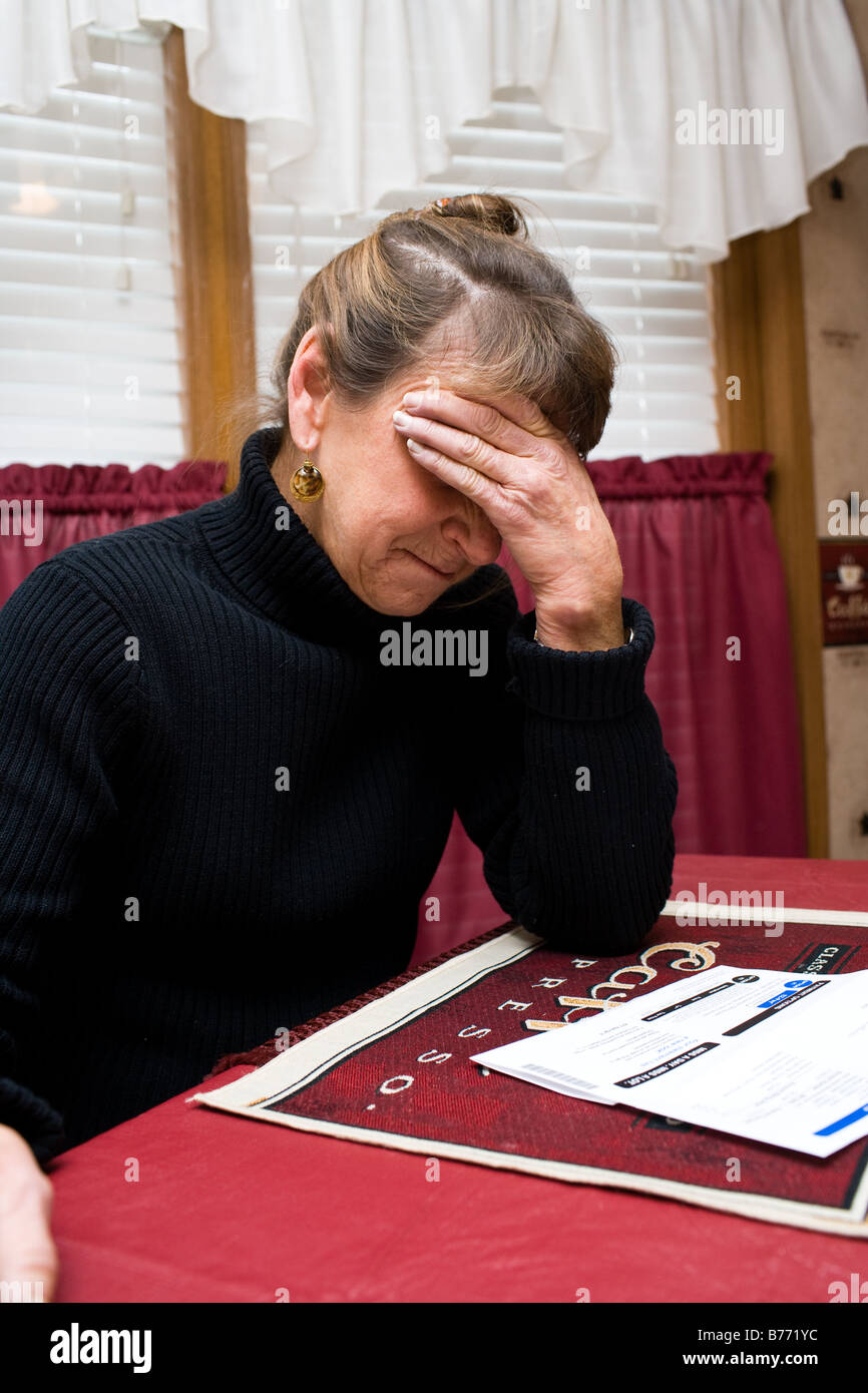 An upset woman unable to pay her bills Stock Photo