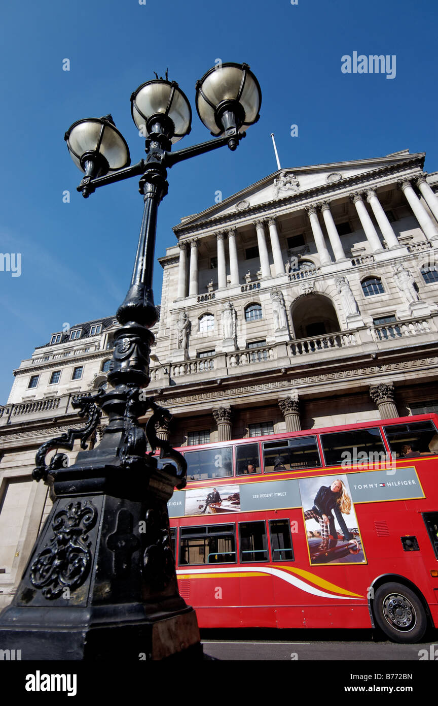 A red london bus passing in front of the Bank of England Stock Photo