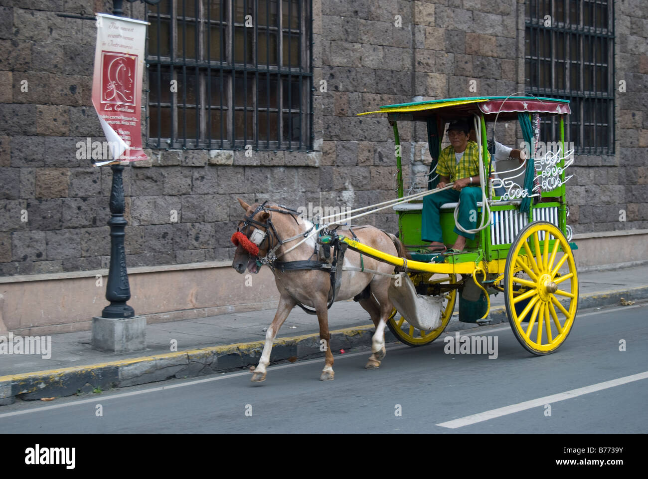 Colourful Calesas (horse-drawn carriage) and driver, Intramuros, Manila, Philippines Stock Photo
