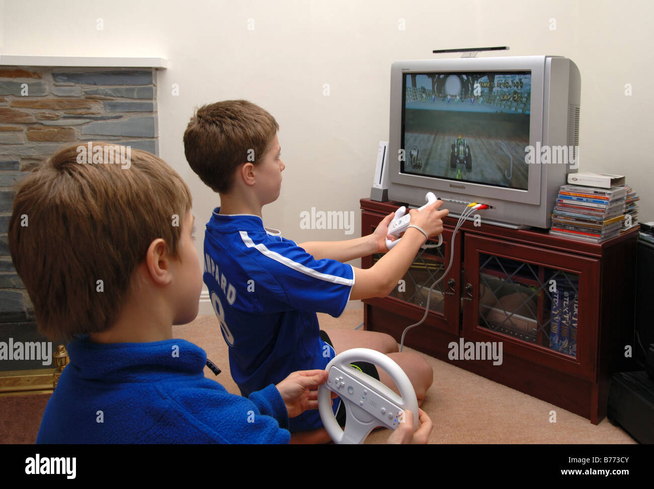 two young boys playing on wii in the living room Stock Photo Alamy