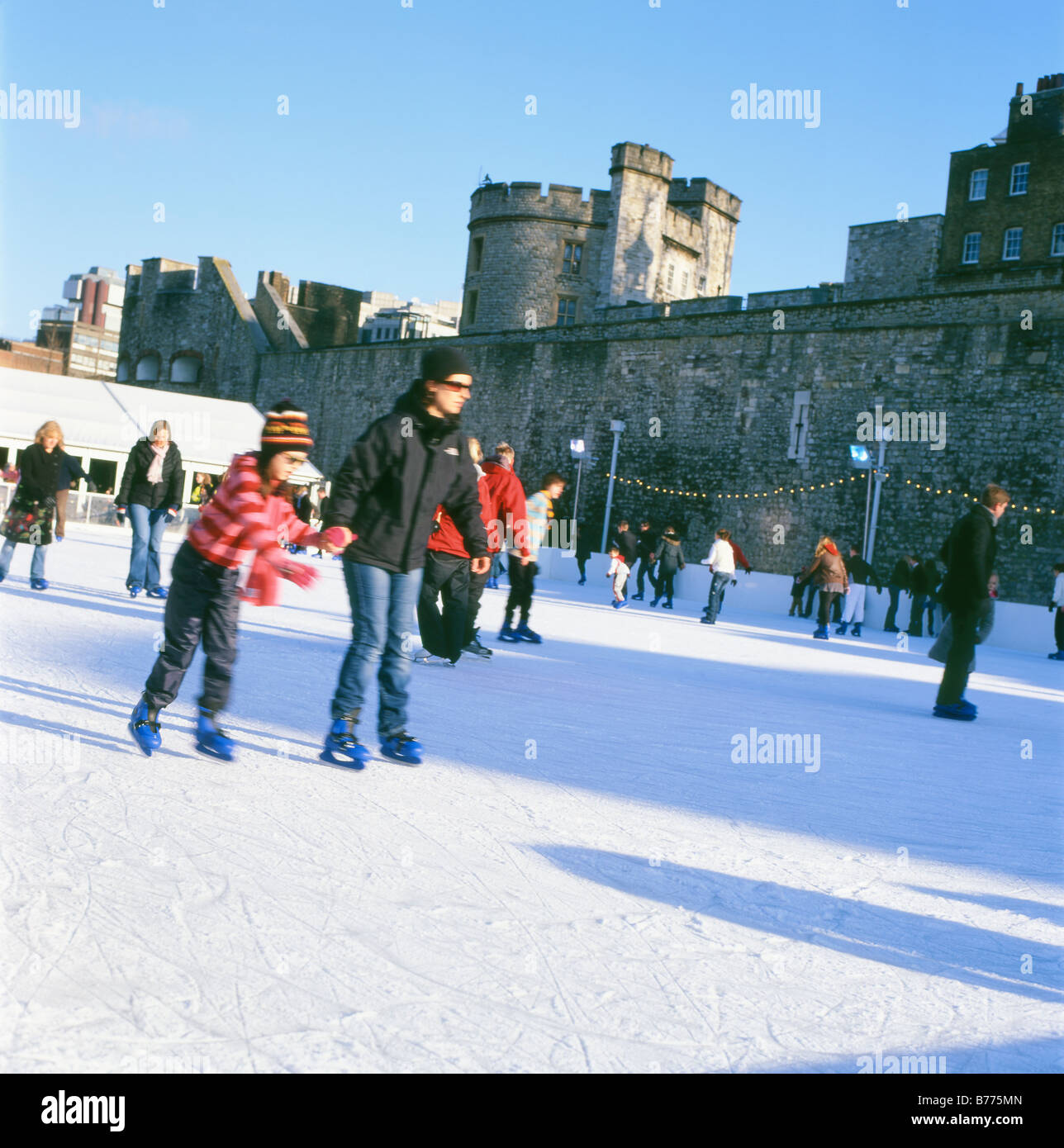 People ice skating at Christmas on the Tower of London ice rink London