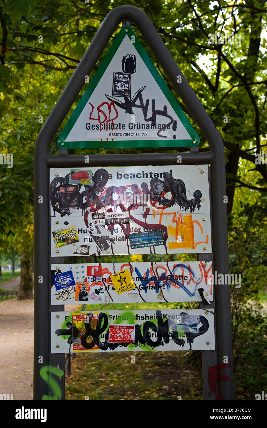 Scrawled over sign covered with scribbles in a park, vandalism Stock Photo