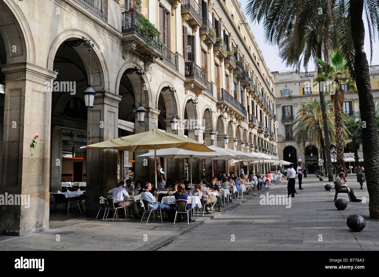 Restaurant, outdoor cafe, people, palm trees, Placa Reial Square, Barcelona, Catalonia, Spain, Europe Stock Photo