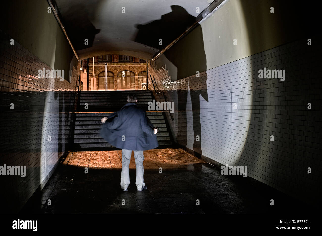 Eery scene of a man in a tunnel at the Warschauer Bruecke in Berlin, Germany, Europe Stock Photo
