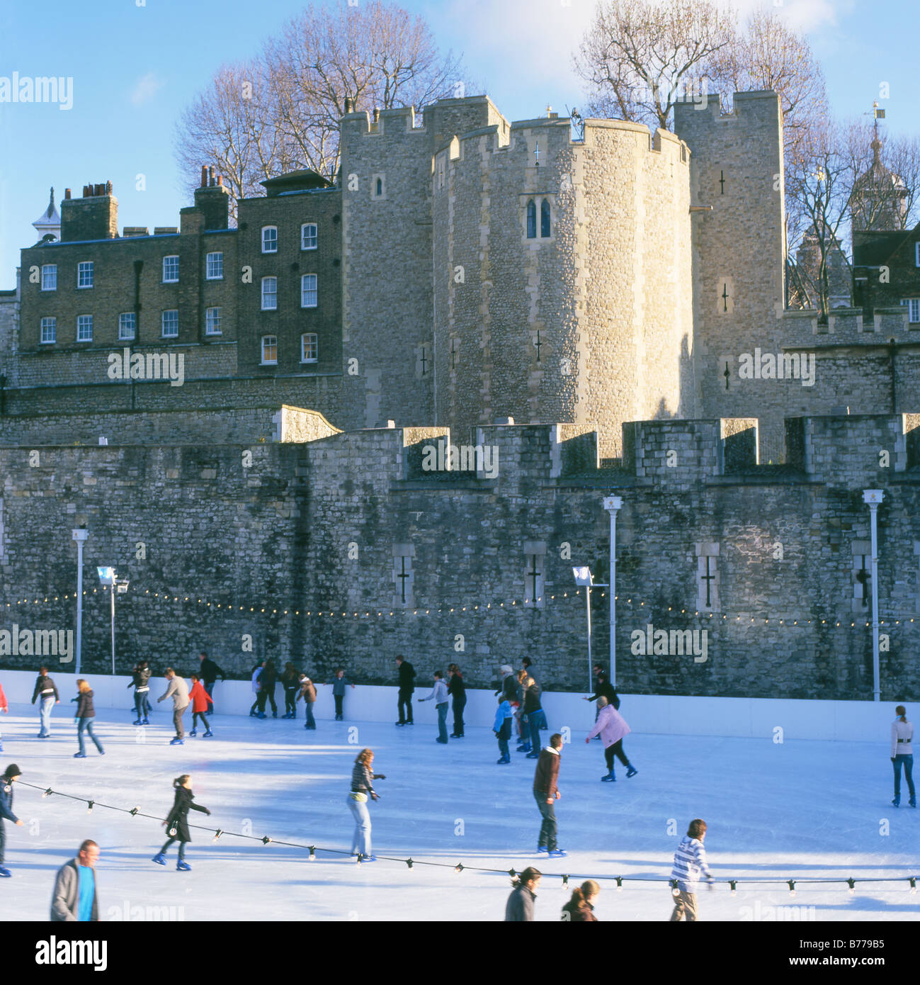 Ice skating at Tower Bridge ice rink London England UK KATHY DEWITT