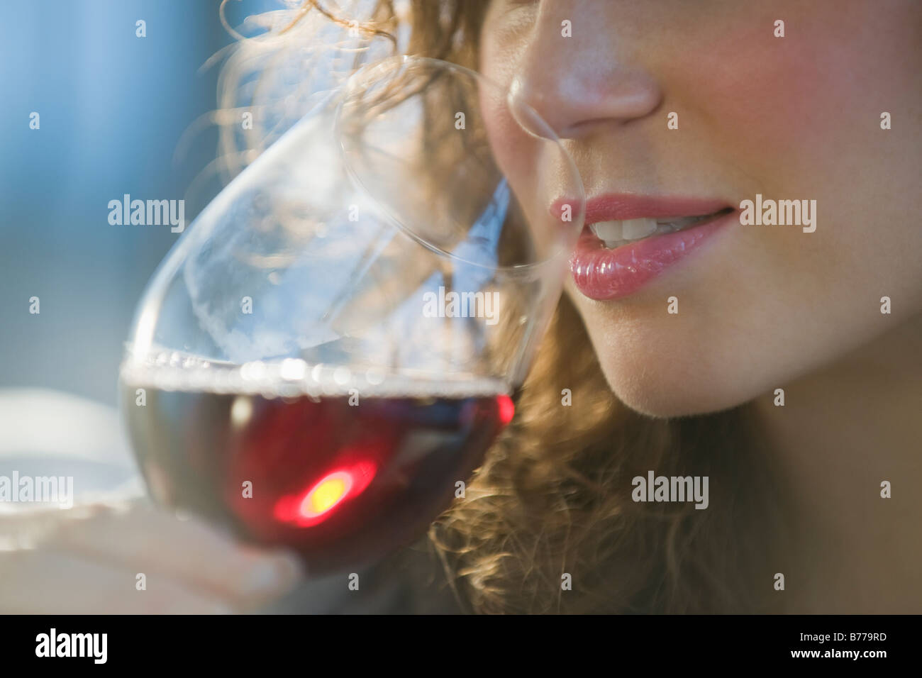 Close up of woman smelling red wine Stock Photo