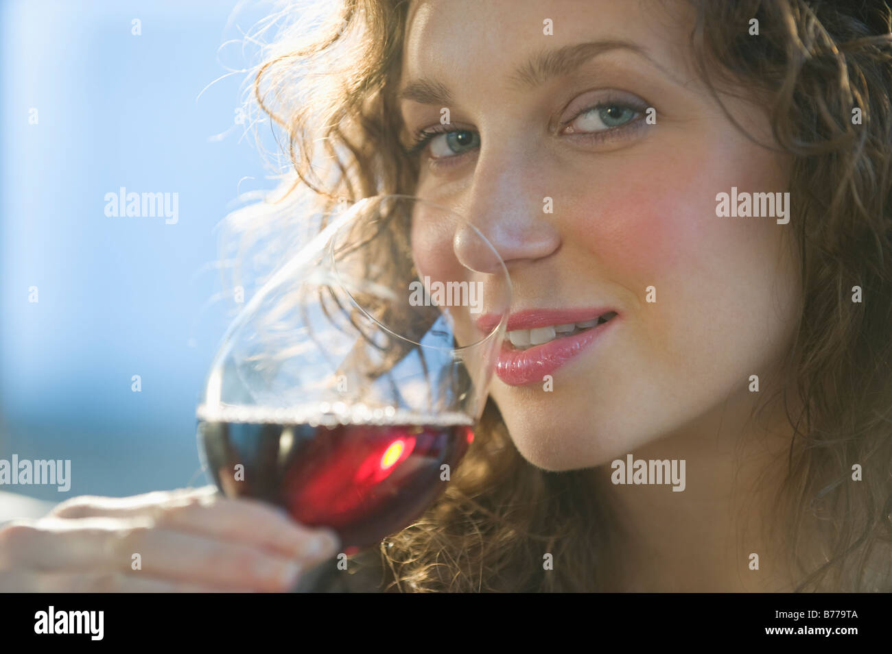 Close up portrait of woman smelling red wine Stock Photo