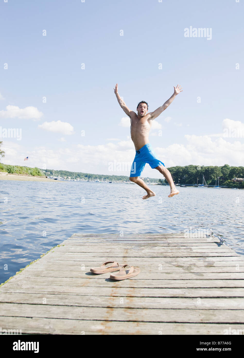 Portrait of man jumping off dock into lake Stock Photo Alamy