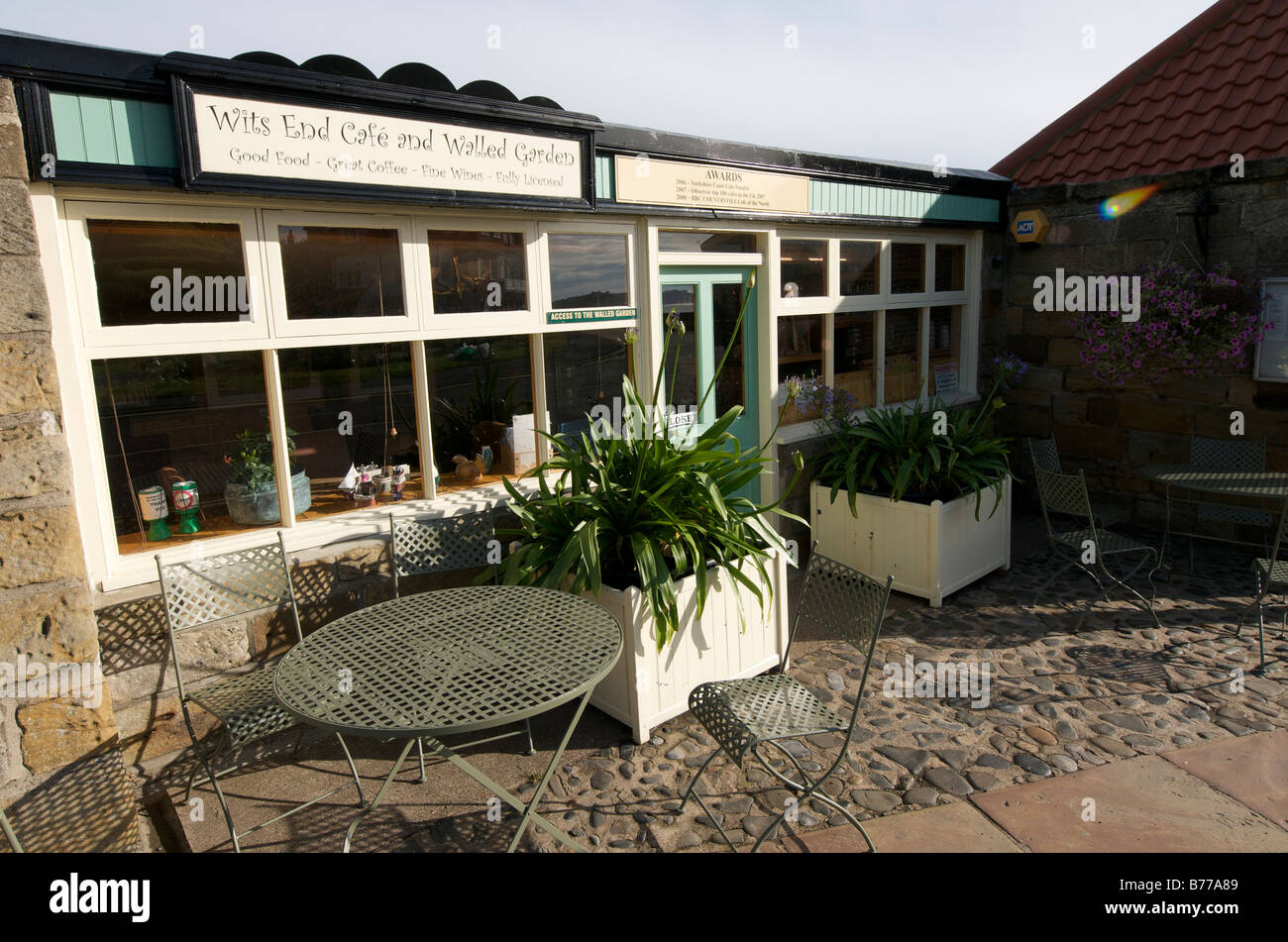 Wits End Cafe with table, seats and Agapanthus plants Stock Photo