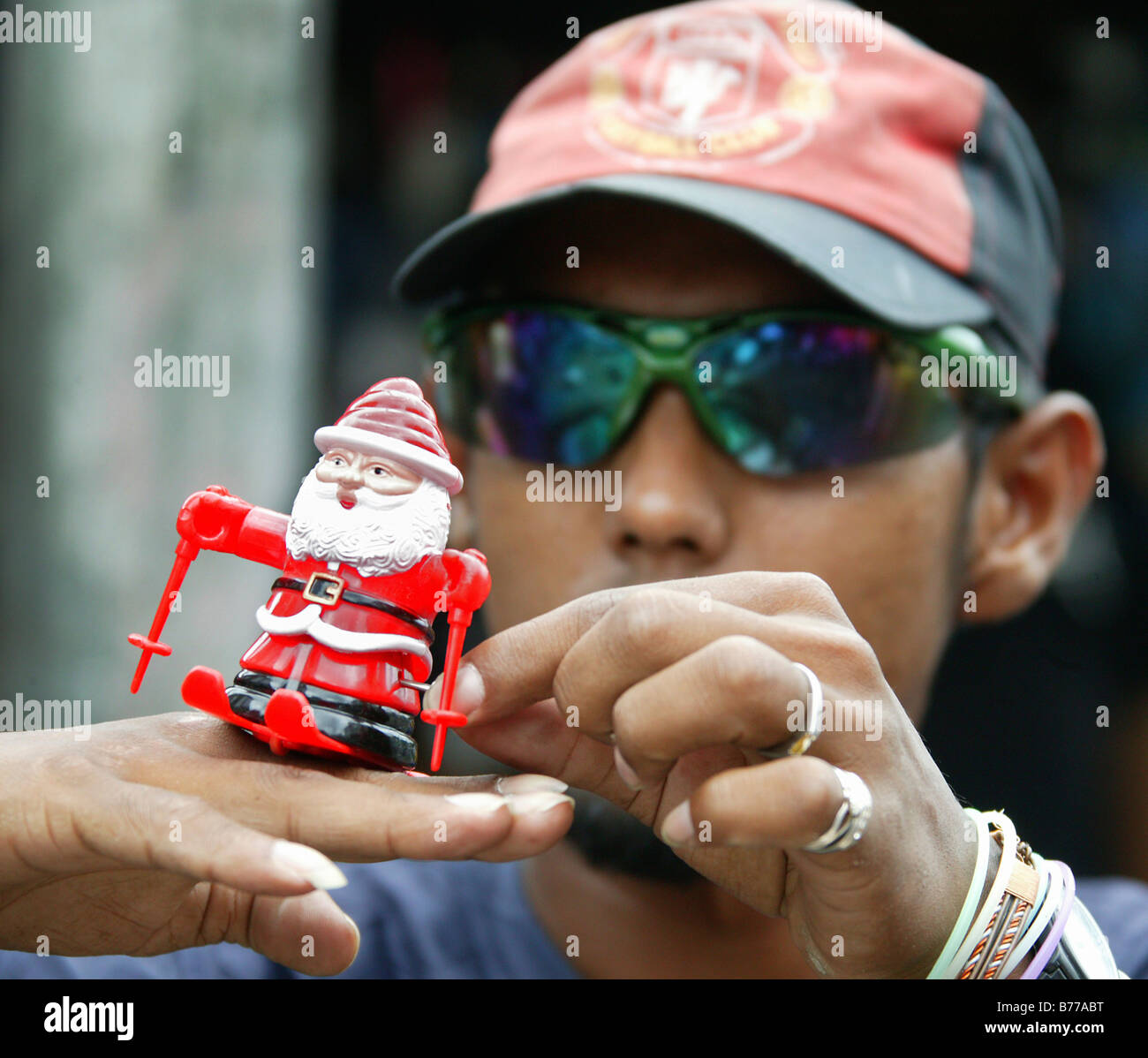 Street hawker with Santa figurine on skis, Port Louis, Mauritius, Indian Ocean, Africa Stock Photo