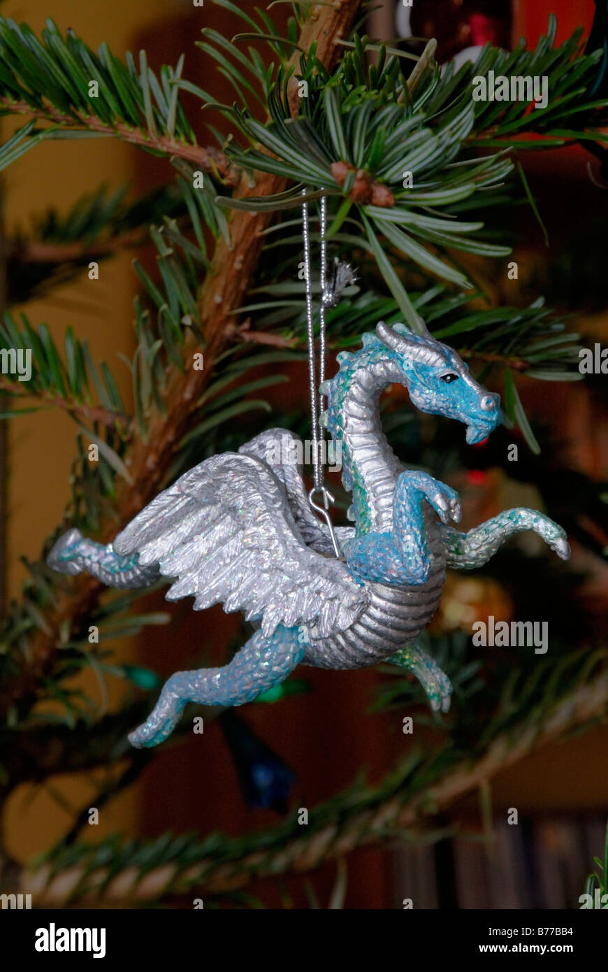 Silver dragon Christmas tree decoration hanging on Xmas tree, England Stock Photo