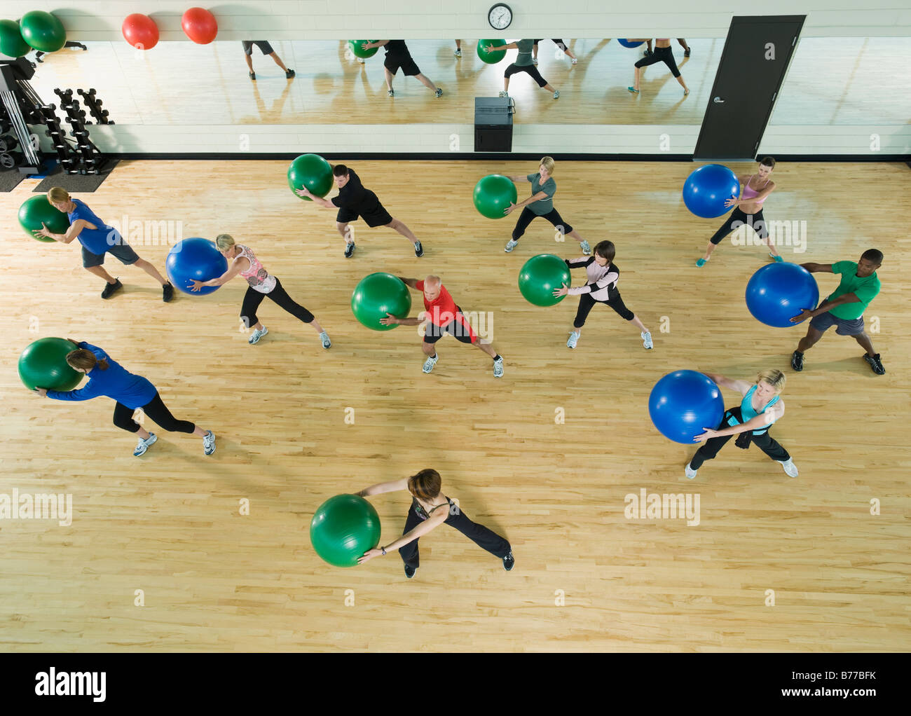 Fitness class holding balance balls Stock Photo