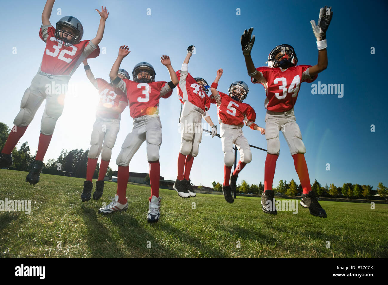 Football players celebrating on field Stock Photo Alamy