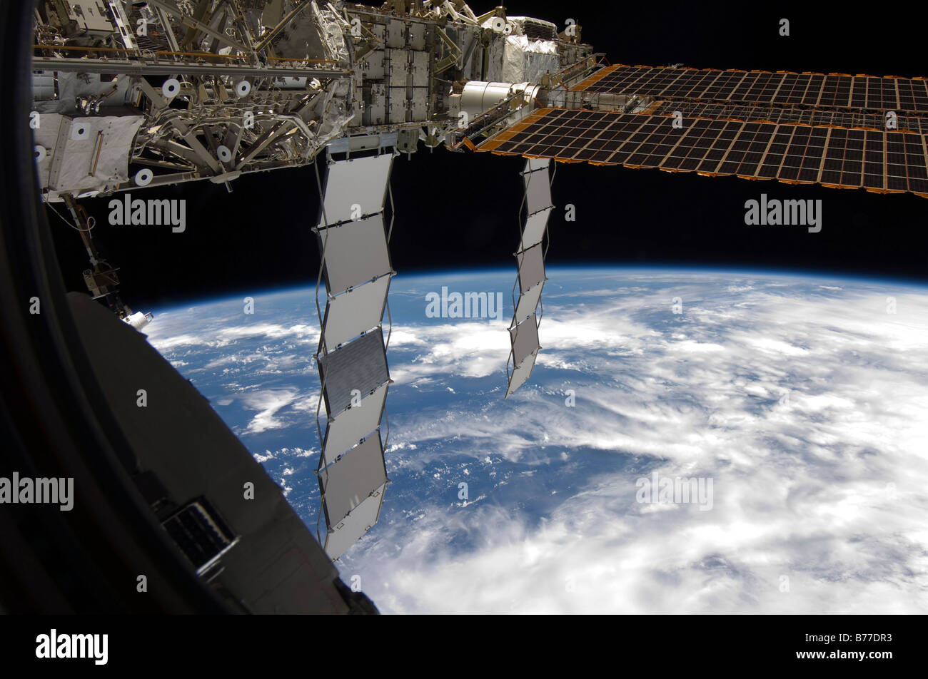 International Space Station backdropped againts a blue and white Earth. Stock Photo