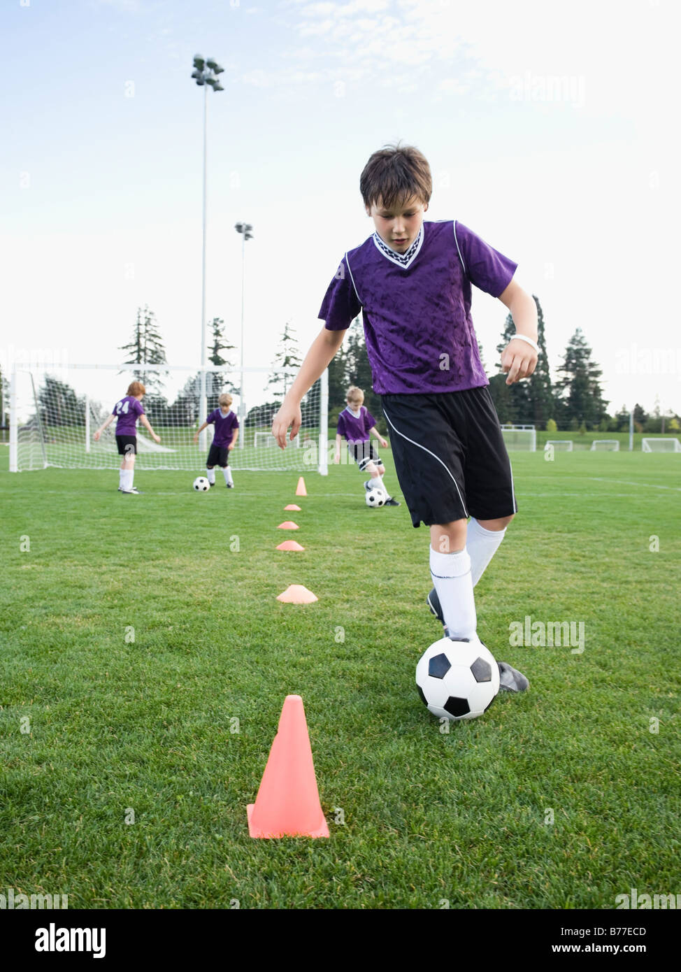 Boy practicing soccer drills Stock Photo