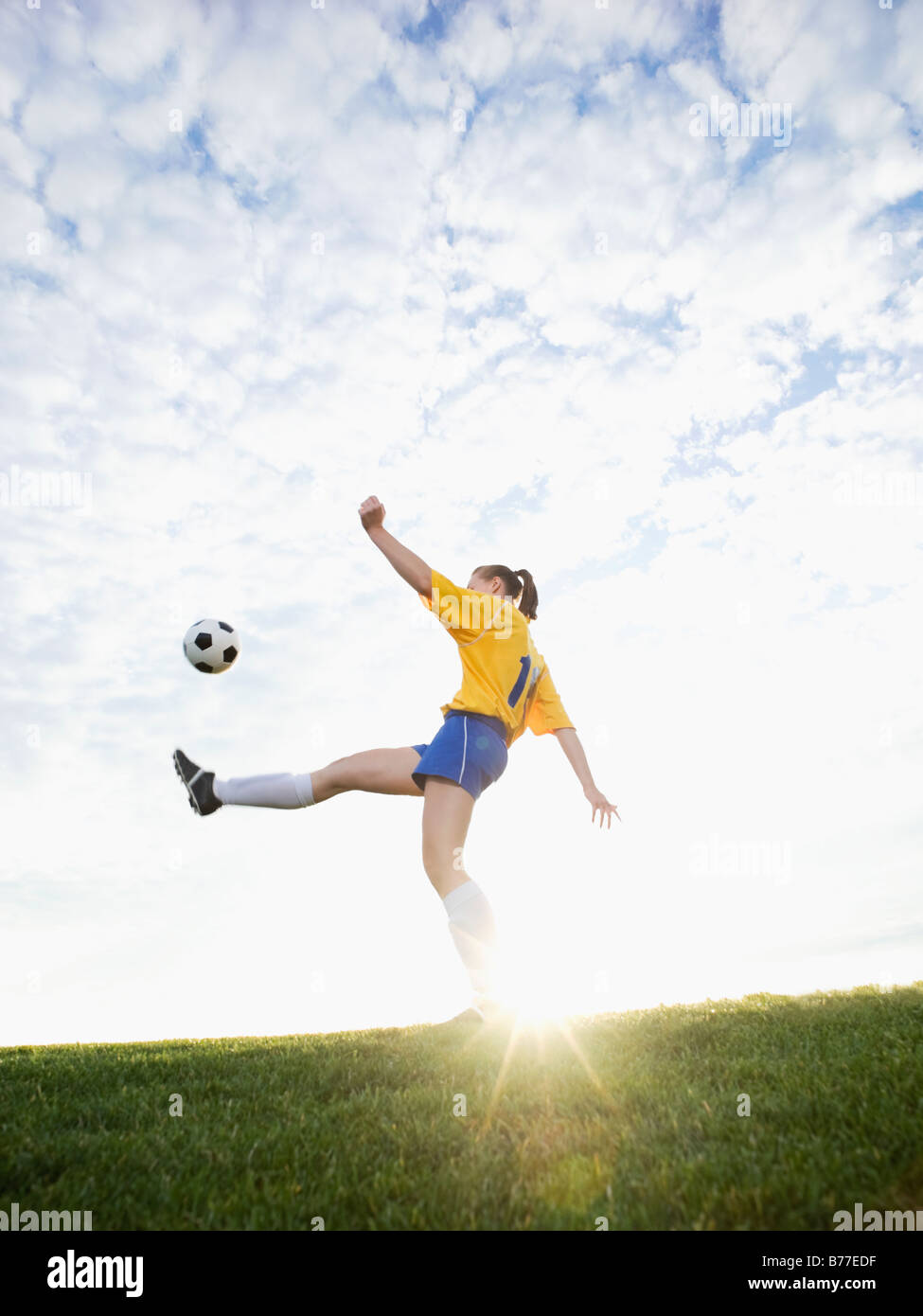 Teenage girl kicking soccer ball Stock Photo Alamy