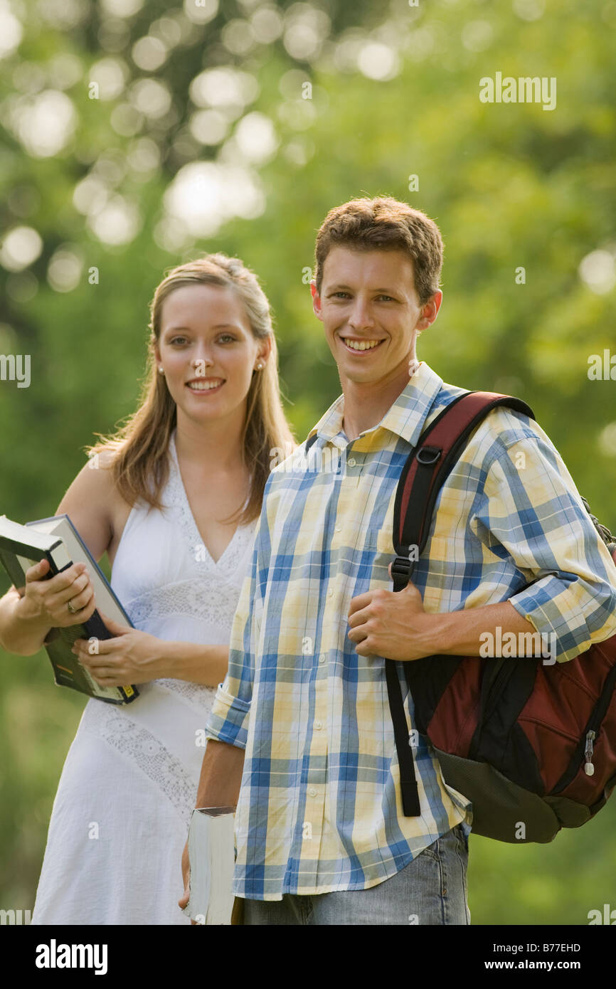 Portrait of college students books and backpack Stock Photo - Alamy