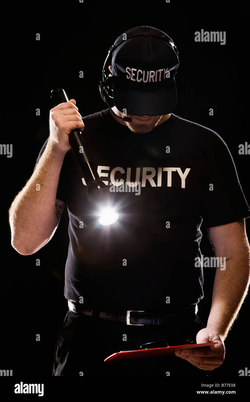 Bouncer looking guest list flashlight hires stock photography and