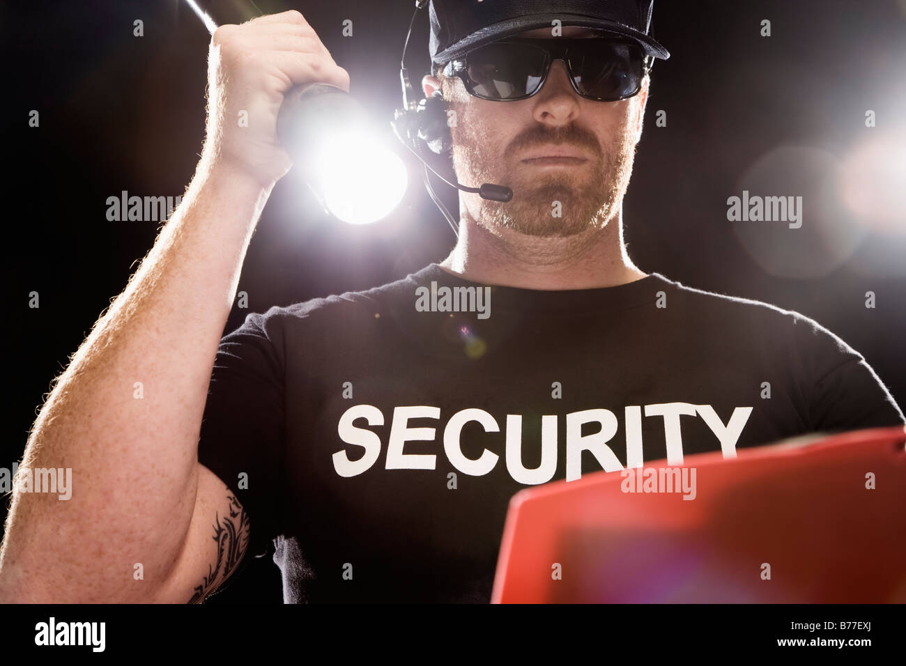 Bouncer looking guest list flashlight Stock Photo