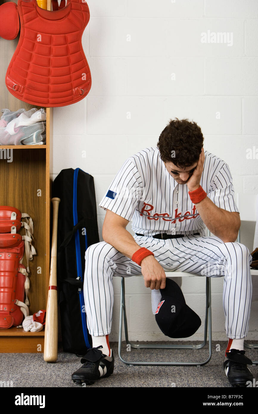 Baseball player sitting head hands locker room Stock Photo Alamy