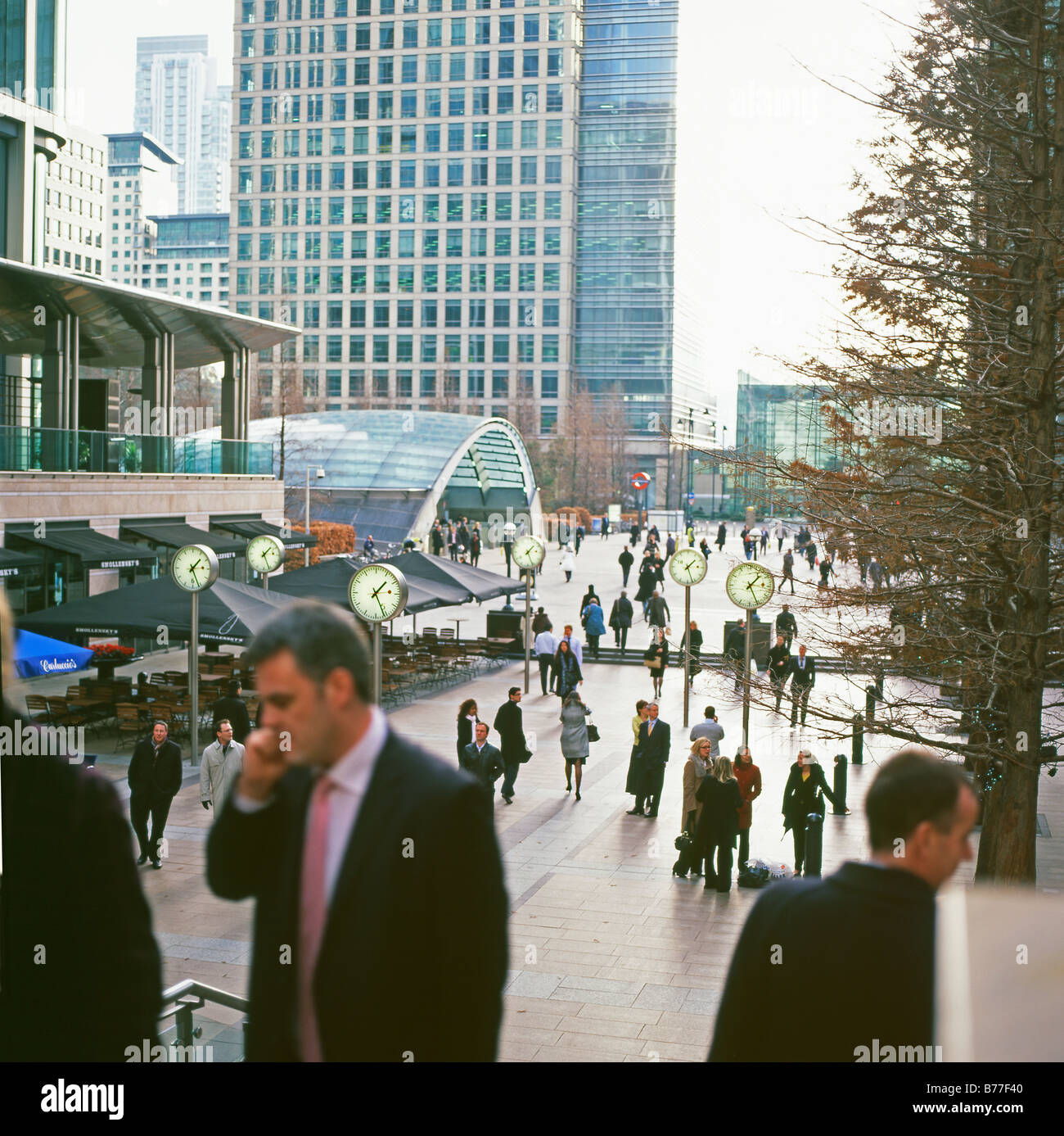 Businessman on a mobile phone and a view of Canada Square, Canary Wharf, London E14 England, UK   KATHY DEWITT Stock Photo