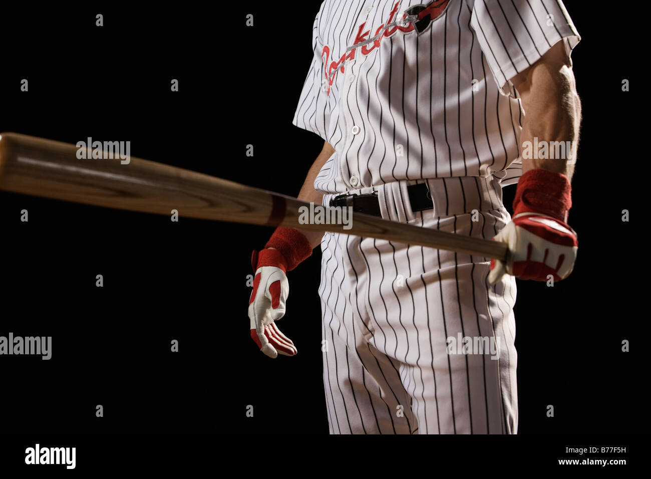 Baseball player holding bat Stock Photo Alamy